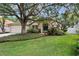 Charming single-Gathering home with a well-maintained front yard and mature trees at 18017 Palm Breeze Dr, Tampa, FL 33647