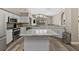 Spacious kitchen features white cabinets, stainless appliances, large windows, and an island with seating at 18017 Palm Breeze Dr, Tampa, FL 33647