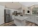 Well-appointed kitchen with stainless steel appliances, granite counters and a center island at 18017 Palm Breeze Dr, Tampa, FL 33647