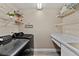 Laundry room featuring front load washer and dryer, storage shelves, and sink at 18017 Palm Breeze Dr, Tampa, FL 33647