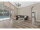 Spacious living room with wood floors, high ceilings, and a sliding glass door to the screened-in pool at 18017 Palm Breeze Dr, Tampa, FL 33647
