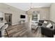 Bright living room features high ceilings, large windows, hardwood flooring, and access to the pool at 18017 Palm Breeze Dr, Tampa, FL 33647