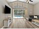 Bright living room offering pool views from a wall of windows and a sliding glass door at 18017 Palm Breeze Dr, Tampa, FL 33647