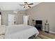Bright main bedroom with a ceiling fan, wood-look flooring, and ensuite bathroom access at 18017 Palm Breeze Dr, Tampa, FL 33647