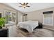Bedroom with wood floors, ceiling fan, and natural light from the sliding glass door at 18017 Palm Breeze Dr, Tampa, FL 33647