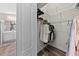 Walk-in closet with rod and shelf storage system, with an ensuite bathroom view at 18017 Palm Breeze Dr, Tampa, FL 33647