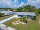 Aerial view of the house and lush green lawn at 1813 Allegheny Dr, Sun City Center, FL 33573