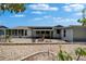 Exterior view of home showcasing patio area with outdoor seating, perfect for entertaining at 1813 Allegheny Dr, Sun City Center, FL 33573