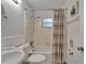 Bathroom features a classic white sink, toilet, and shower/tub combination with striped curtain at 1813 Allegheny Dr, Sun City Center, FL 33573