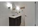 Bathroom with white subway tile walls and a dark vanity cabinet with white countertop at 1813 Allegheny Dr, Sun City Center, FL 33573