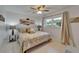 Bedroom with a ceiling fan, neutral tones, and a window providing natural light at 1813 Allegheny Dr, Sun City Center, FL 33573