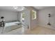 Bright bedroom with tiled flooring, neutral walls, and direct access to the exterior at 1813 Allegheny Dr, Sun City Center, FL 33573