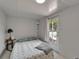 Sun-lit bedroom features tiled floor, neutral walls, and exterior access for convenience at 1813 Allegheny Dr, Sun City Center, FL 33573