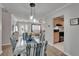 Dining area featuring modern chairs, lighting, and an open-concept view of the kitchen at 1813 Allegheny Dr, Sun City Center, FL 33573