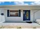 Stylish front door with window and blue shutters at 1813 Allegheny Dr, Sun City Center, FL 33573