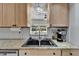 Kitchen sink with granite counters, stainless steel dishwasher and views to the exterior at 1813 Allegheny Dr, Sun City Center, FL 33573