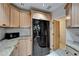 Well-lit kitchen showcasing stainless steel appliances, granite counters, and light wood cabinets at 1813 Allegheny Dr, Sun City Center, FL 33573
