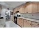 Cozy kitchen boasting sleek appliances, granite counters, and ample light wood cabinet space at 1813 Allegheny Dr, Sun City Center, FL 33573