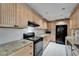 Spacious kitchen featuring granite countertops, black appliances and custom cabinetry at 1813 Allegheny Dr, Sun City Center, FL 33573