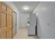 Clean laundry area with stackable washer and dryer, next to storage area at 1813 Allegheny Dr, Sun City Center, FL 33573