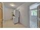 Efficient laundry room with stacked washer and dryer, and tile flooring at 1813 Allegheny Dr, Sun City Center, FL 33573