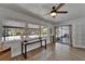 Bright office with wood floors, desk, shelving, and large windows overlooking outdoor patio at 1813 Allegheny Dr, Sun City Center, FL 33573