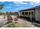 Outdoor patio with lounge chairs and beautiful landscaping at 1813 Allegheny Dr, Sun City Center, FL 33573