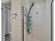 A modern shower features sleek white tile and a contemporary blue shower column and fixtures at 1813 Allegheny Dr, Sun City Center, FL 33573