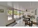 Bright sunroom with tile floor, ceiling fan, dining table and view of a screened in patio at 1813 Allegheny Dr, Sun City Center, FL 33573