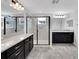 Elegant bathroom with dual vanities, quartz countertops, dark cabinets, and a glass-enclosed shower at 19238 Old Spanish Rd, Tampa, FL 33647