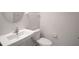 Clean powder room with a white toilet and sink, perfect for guests at 19238 Old Spanish Rd, Tampa, FL 33647