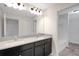A modern bathroom with double sinks, a large mirror, and a shower-tub combo at 19238 Old Spanish Rd, Tampa, FL 33647