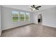 Spacious bedroom with hardwood floors and three windows offering natural light at 19238 Old Spanish Rd, Tampa, FL 33647