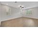Bright bedroom with hardwood floors and three windows offering natural light at 19238 Old Spanish Rd, Tampa, FL 33647