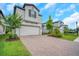 Charming two-story home with manicured landscaping, brick driveway, and a two-car garage at 19238 Old Spanish Rd, Tampa, FL 33647
