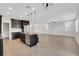 Modern kitchen featuring a granite island, stainless steel appliances, dark cabinets and wood laminate flooring at 19238 Old Spanish Rd, Tampa, FL 33647