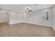 Large living room with wood flooring, ceiling fan, and natural lighting at 19238 Old Spanish Rd, Tampa, FL 33647