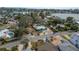 Single-story home with a metal roof, lush yard, and mature landscaping in a waterfront community at 2010 Bayview Pl, Indian Rocks Beach, FL 33785