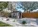 Well-kept shed area with pea gravel and landscaping provides utility and charm to the backyard at 2010 Bayview Pl, Indian Rocks Beach, FL 33785
