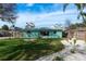 Well-maintained backyard features lush lawn, gravel, and vibrant landscaping, creating an inviting outdoor space at 2010 Bayview Pl, Indian Rocks Beach, FL 33785