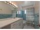 Charming blue and white bathroom with retro tile, a decorative light fixture, and a shower-tub combo at 2010 Bayview Pl, Indian Rocks Beach, FL 33785