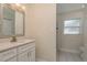 Well-lit bathroom boasts a modern vanity with decorative lighting and a walk-in shower at 2010 Bayview Pl, Indian Rocks Beach, FL 33785