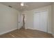 Bright bedroom offers wood floors, a closet, and ample natural light from the sliding door and windows at 2010 Bayview Pl, Indian Rocks Beach, FL 33785