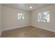 Bright bedroom with tile floors, two windows, and a ceiling fan provides a comfortable space at 2010 Bayview Pl, Indian Rocks Beach, FL 33785
