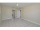 Spacious bedroom with tile flooring, a ceiling fan, and two open doorways to other rooms at 2010 Bayview Pl, Indian Rocks Beach, FL 33785
