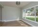 Bright dining area features wood floors and a large window overlooking the manicured backyard at 2010 Bayview Pl, Indian Rocks Beach, FL 33785