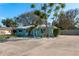 Charming single-story home with an eye-catching blue exterior and well-manicured landscaping at 2010 Bayview Pl, Indian Rocks Beach, FL 33785