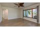 Sunlit living room with wood-look flooring and a large window offering pleasant outdoor views at 2010 Bayview Pl, Indian Rocks Beach, FL 33785