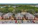 Aerial view of apartment complex with lush greenery, lake views, and ample parking at 21032 Voyager Blvd # 8, Land O Lakes, FL 34638