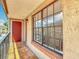 Apartment balcony with tiled floor, covered ceiling, and large window with privacy blinds at 21032 Voyager Blvd # 8, Land O Lakes, FL 34638